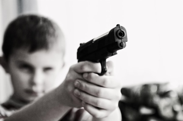 Stunning Free Black and White Stock Photos: Child Holding a Gun
