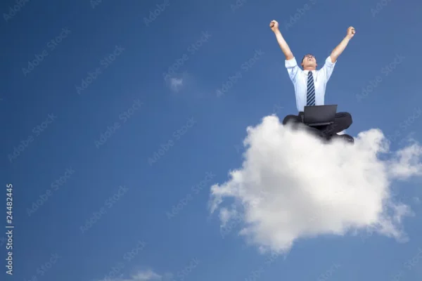 Person with Computer Sitting on a Cloud