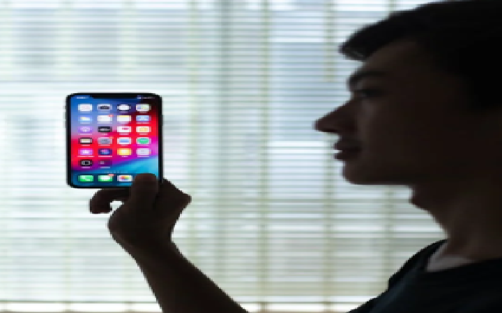 A person holding a phone, focused on social media—perfect for '10 Graphic Design Hacks to 10X Your Social Media Growth.